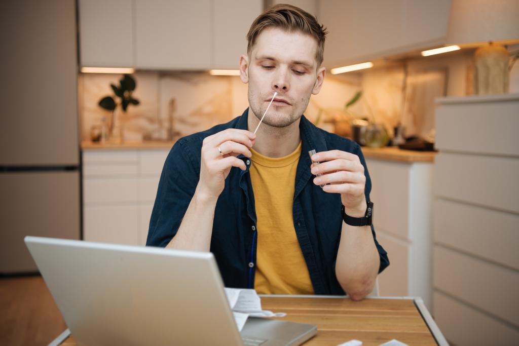 man holding swab to nose