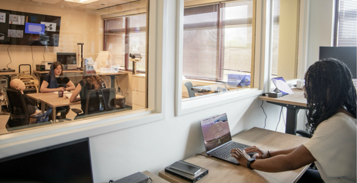 woman observing interview through 2-way glass