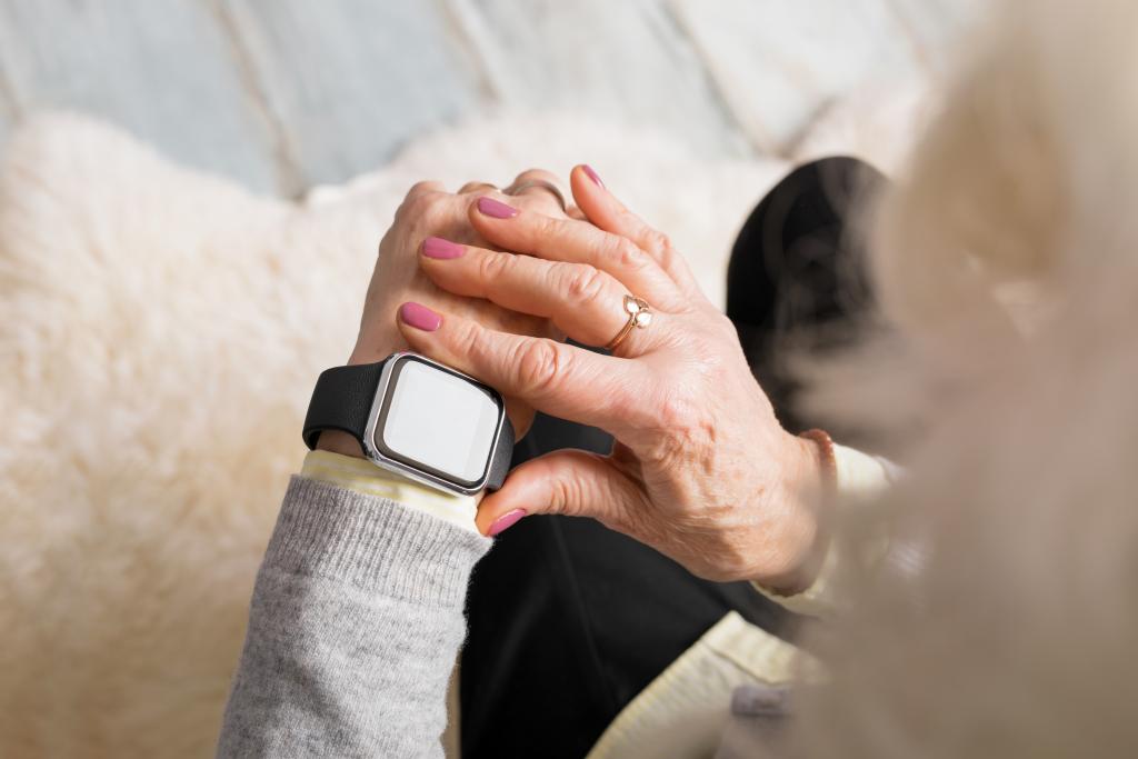 hands of an older adult with a smart watch