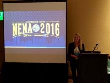 A picture of Christina Touzet standing next to a podium presenting a presentation on Accessible Emergency Alerts for People with Disabilities at NENA Conference 